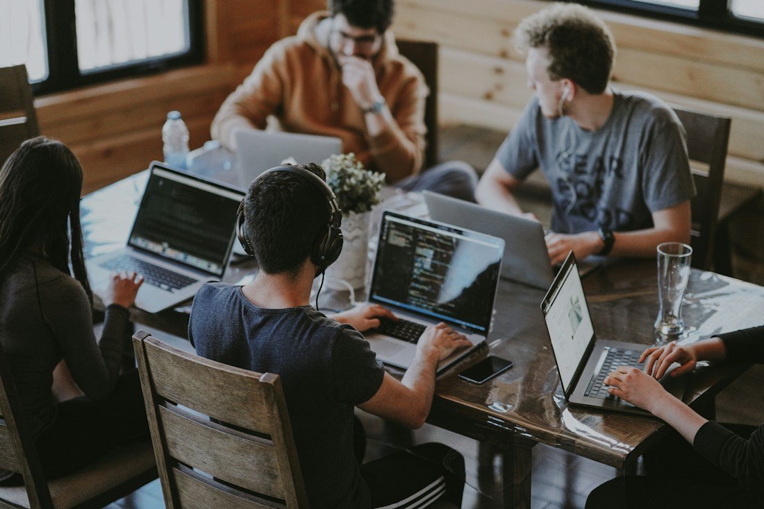 Creative collaborators planning around a laptop